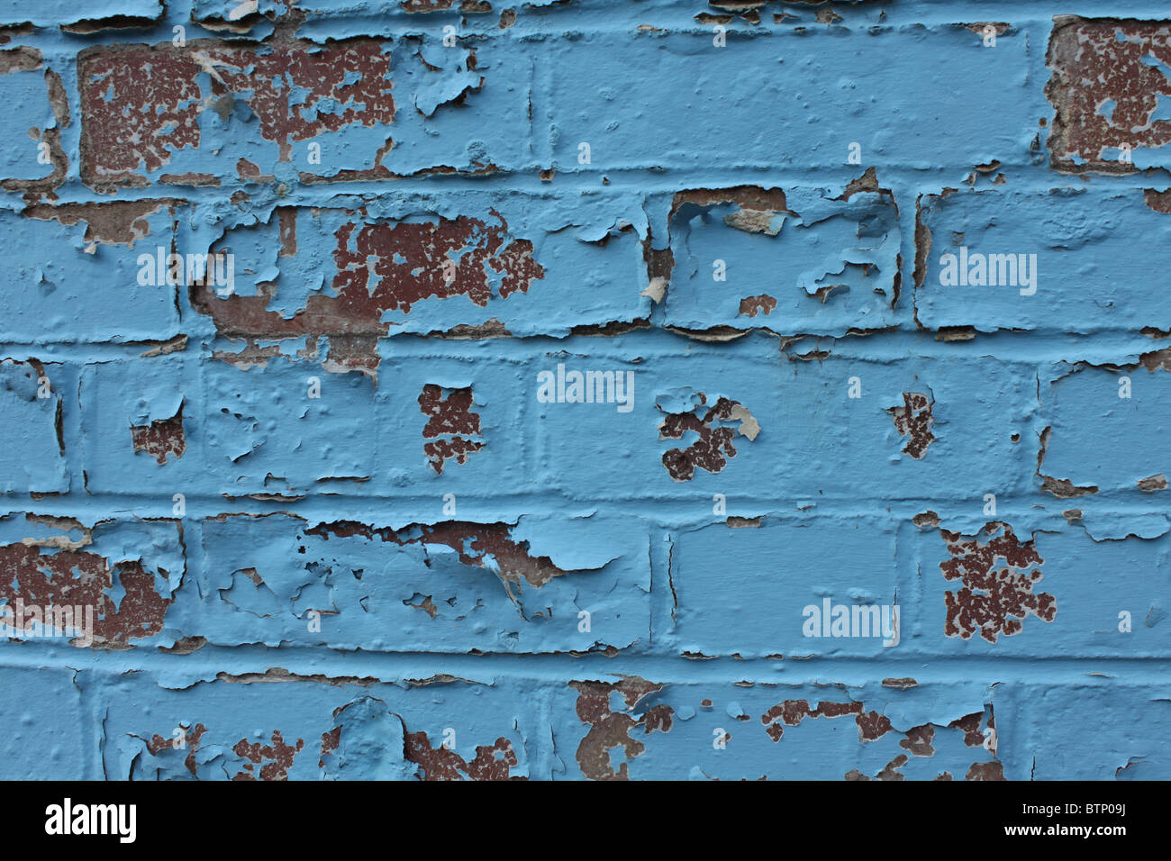 Brick wall with blue paint peeling off Stock Photo Alamy