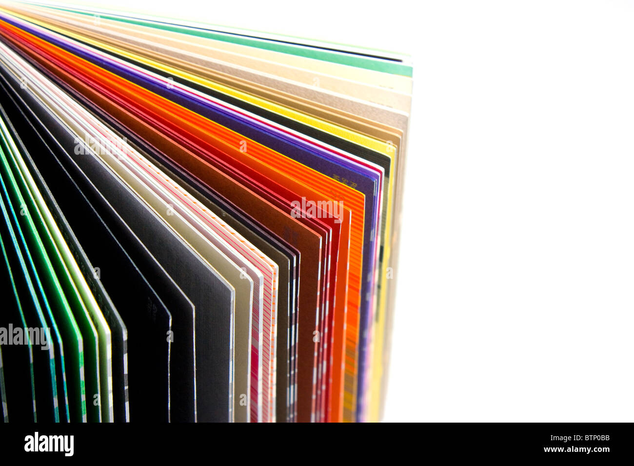 coloured papers bound in a book on white background Stock Photo Alamy