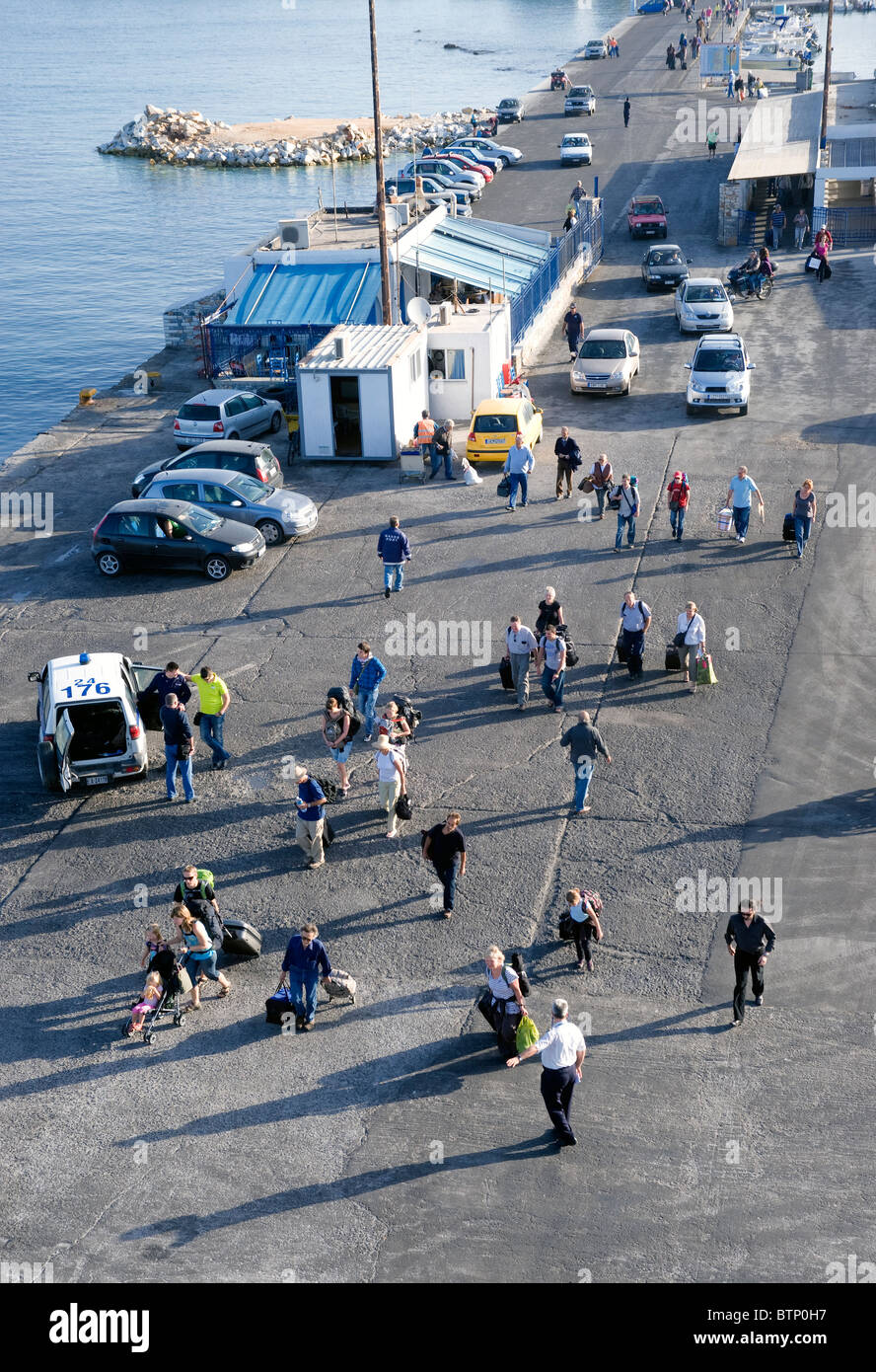 Travelers embarking on a ferry in the port of Hora, on the Greek Cyclade island of Naxos. Stock Photo