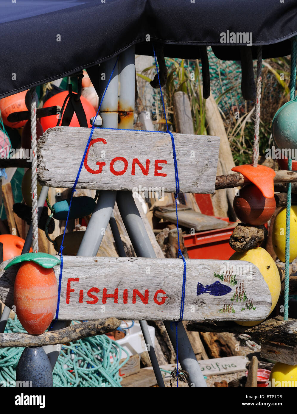 ' gone fishing ' sign at an artists studio in Porthleven, Cornwall, UK Stock Photo