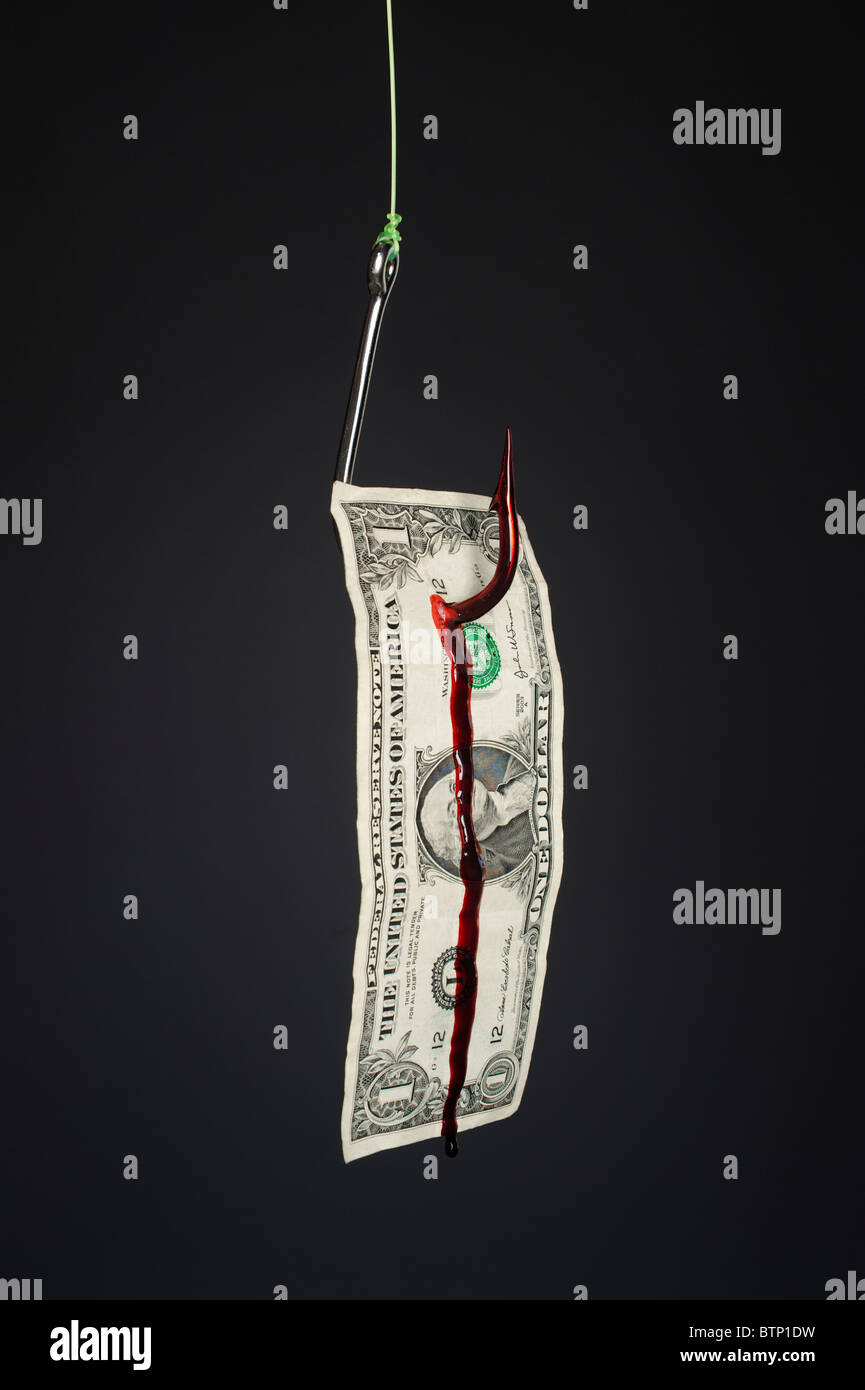 A bleeding dollar bill on a stainless steel fish hook against a slight gray gradient backdrop. Stock Photo