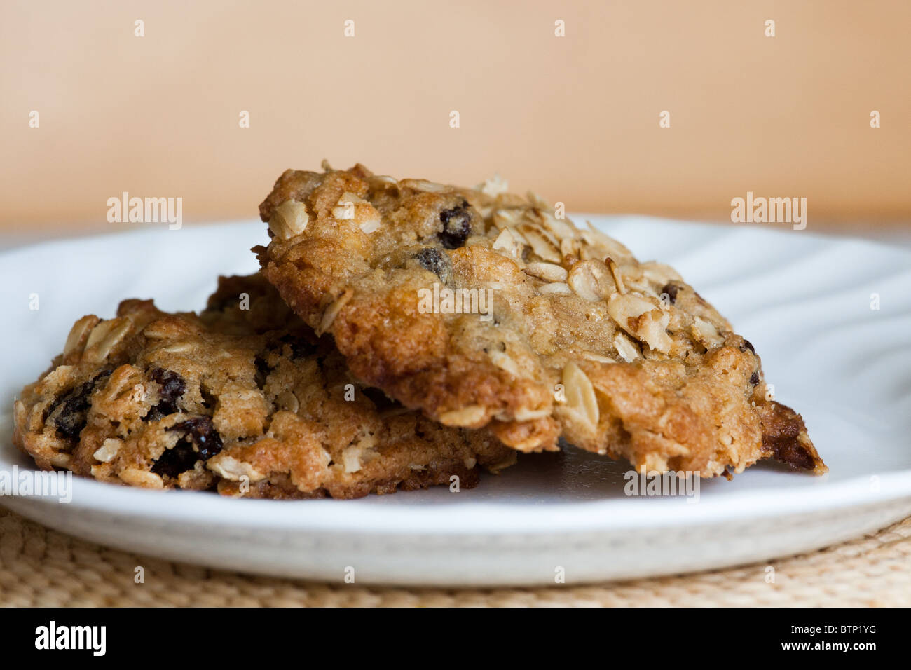 home made baked oatmeal raisin cookie white plate Stock Photo