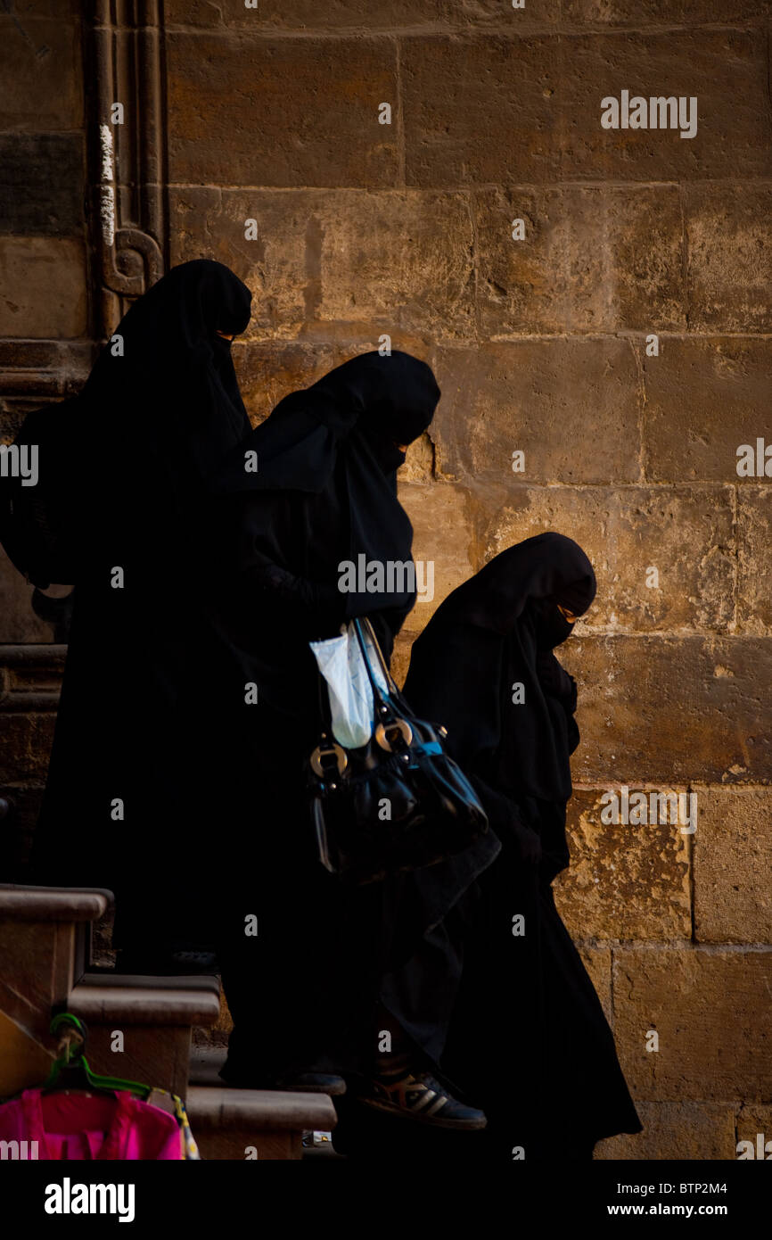 Muslim women in burqas walk down steps at the Al-Ghouri complex in Cairo, Egypt. Stock Photo