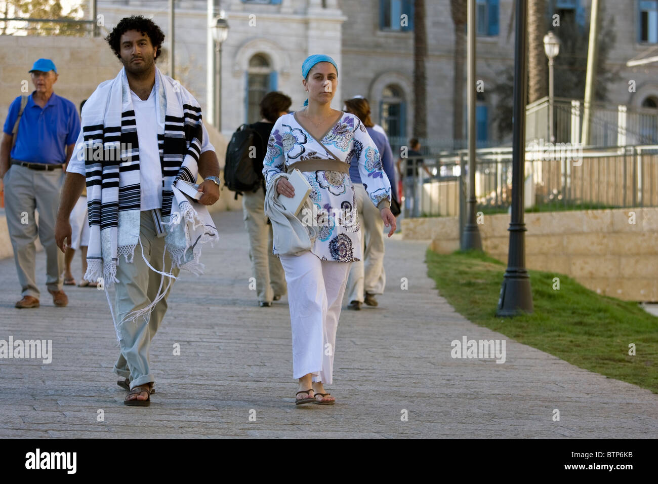 Jewish people dressed in traditional religious clothes go to the