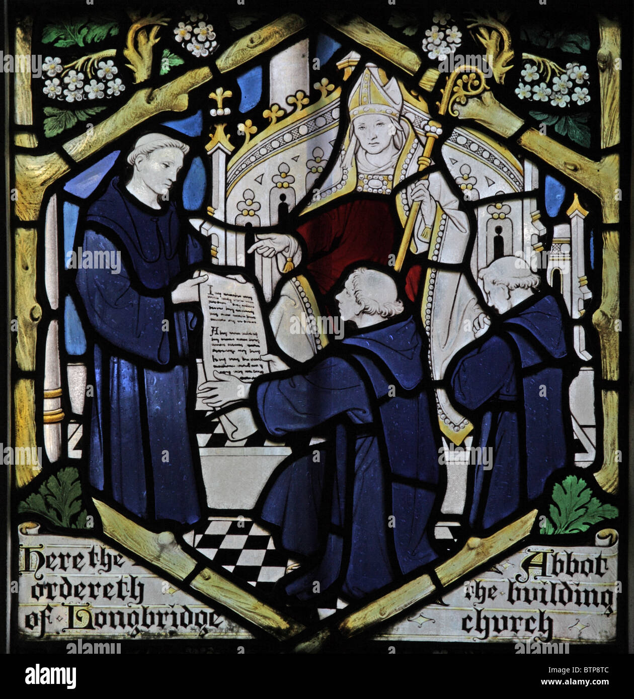A stained glass window depicting the Abbot ordering the building of Longbridge Deverill Church by F C Eden. Story of Glastonbury. Stock Photo
