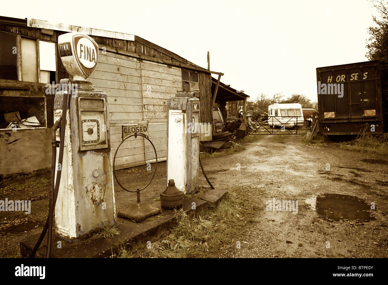Old petrol pumps on garage forecourt in Whitechapel village,Lancashire,England Stock Photo