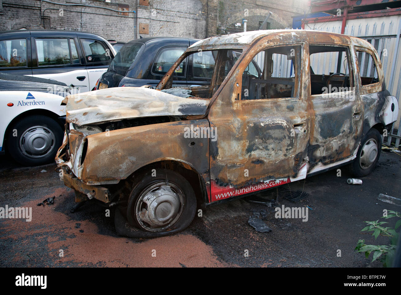 burned out taxi in london Stock Photo Alamy