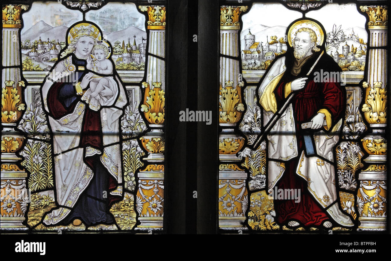 A stained glass window by C E Kempe and Co.depicting The Madonna and Child and Saint Joseph Stock Photo