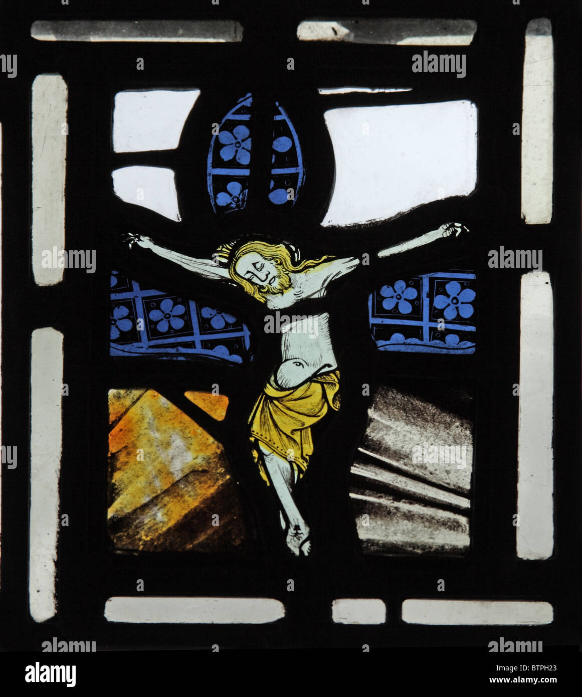 A medieval stained glass window depicting The Crucifixion, Parish Church of St Michael, Wilsford, Wiltshire Stock Photo
