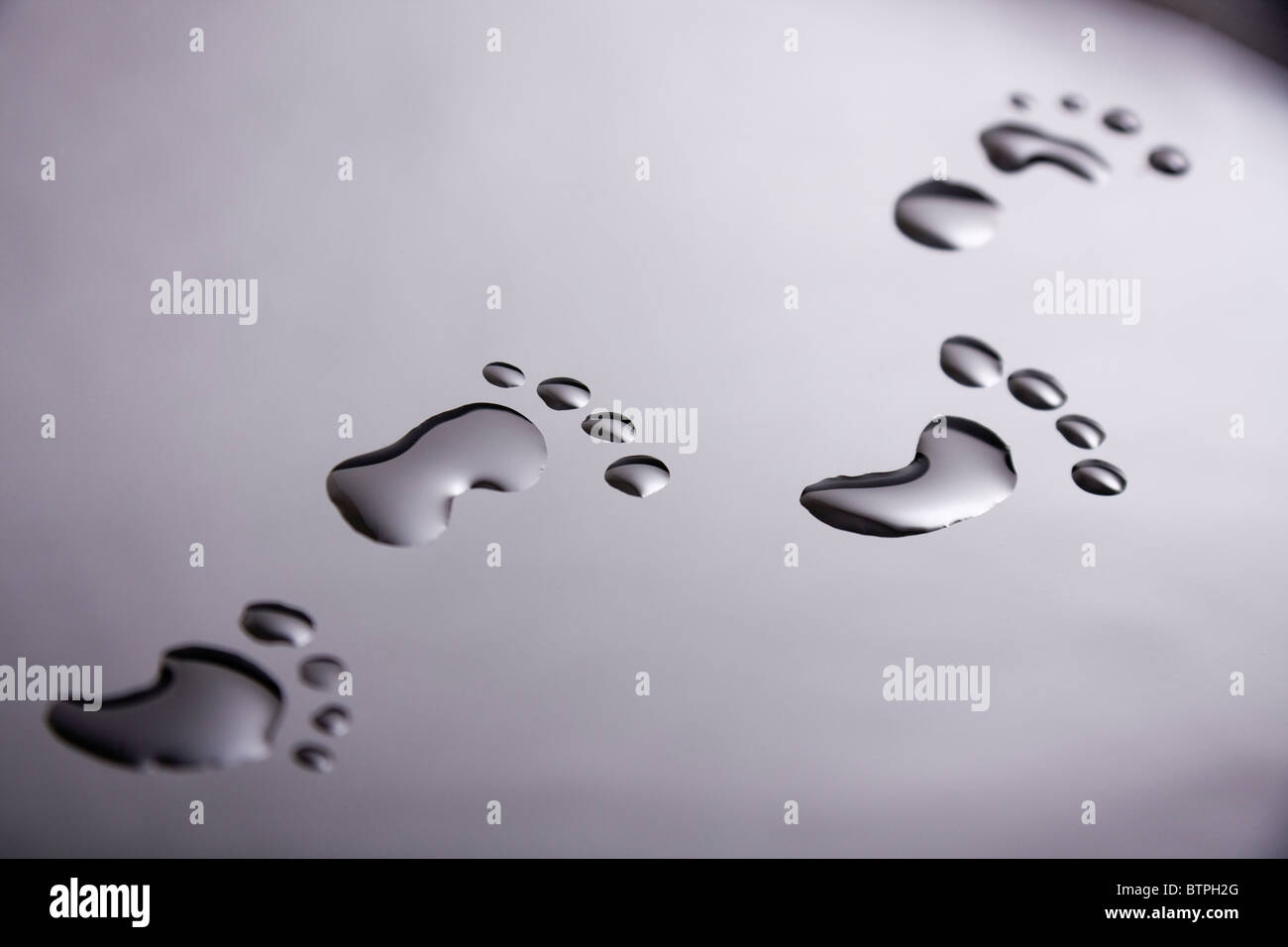 Footprints made from water drops Stock Photo
