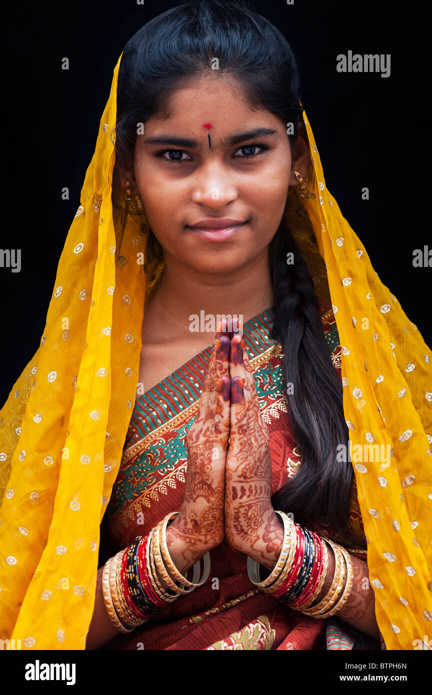 Indian girl wearing traditional silk sari with henna prayer hands. India Stock Photo
