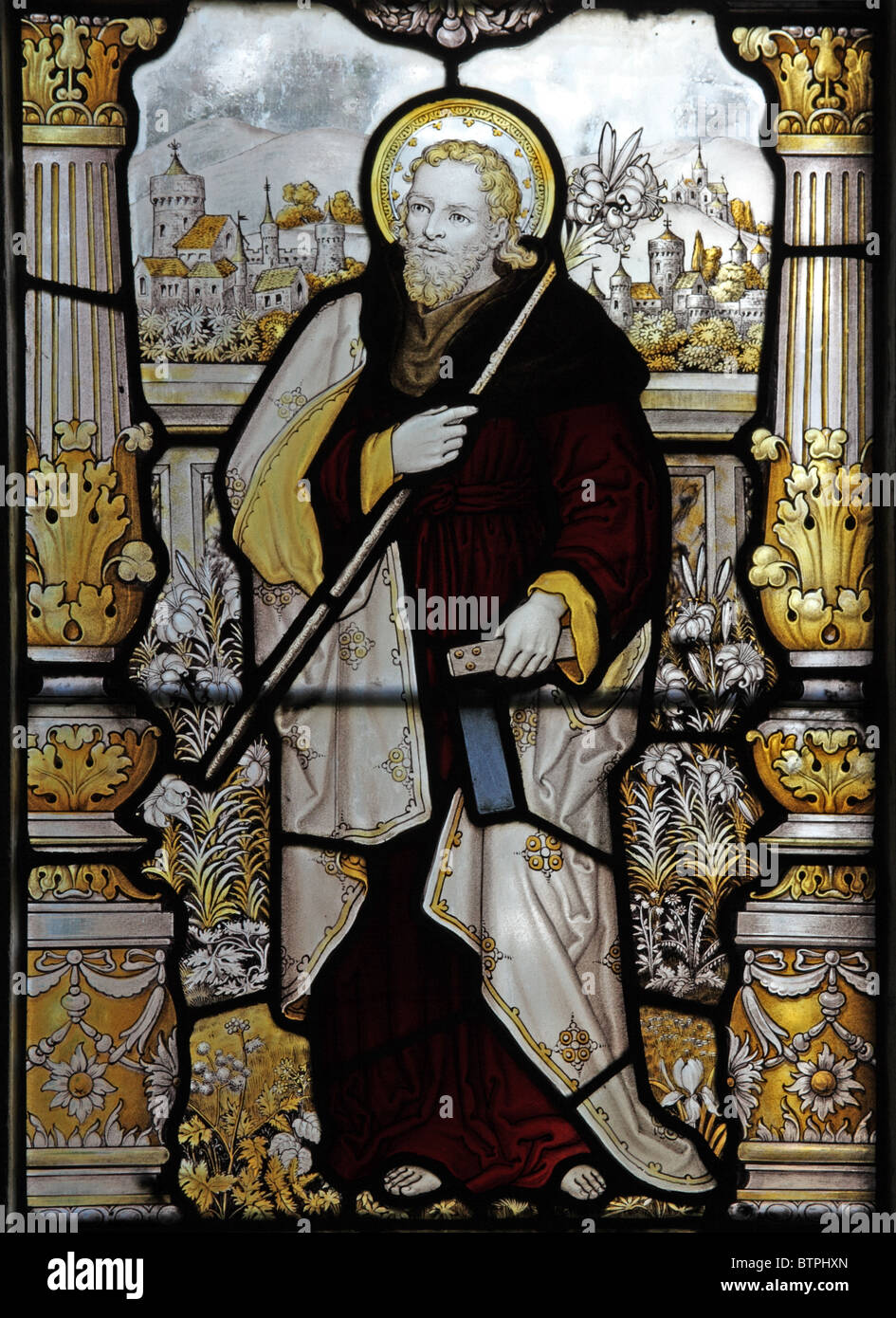 A stained glass window by C E Kempe and Co. depicting Saint Joseph holding a carpenter's square Stock Photo
