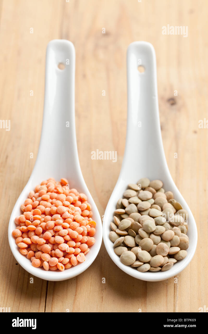 the red and brown lentils in porcelain spoon Stock Photo