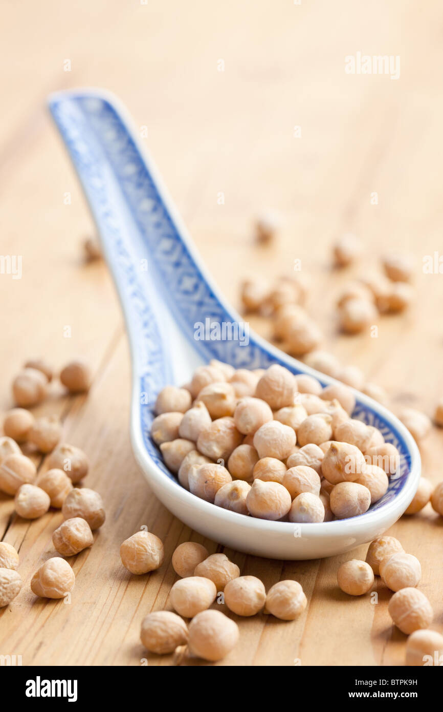 chickpeas in porcelain spoon Stock Photo