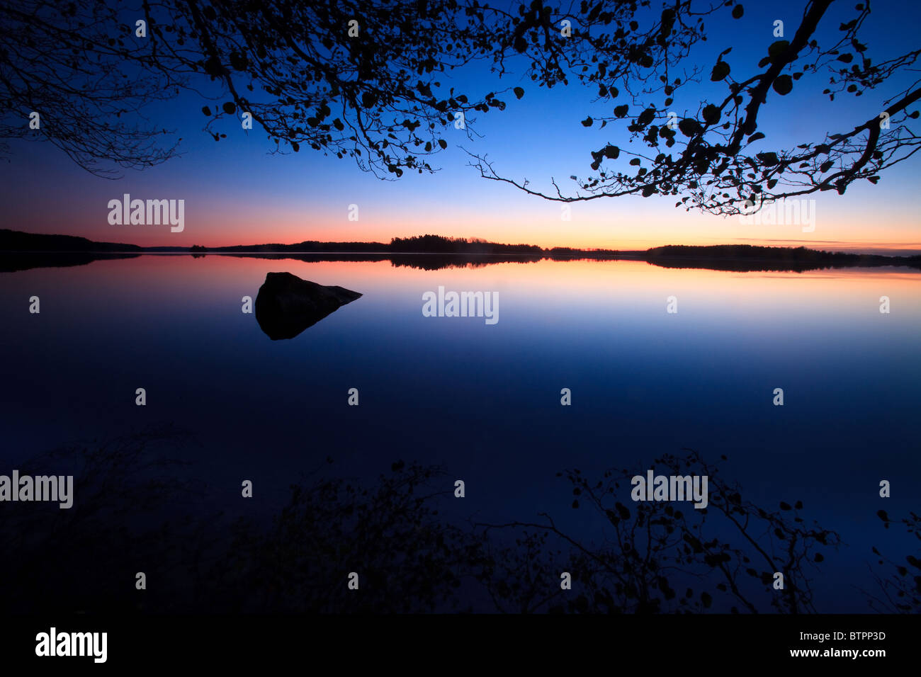 Colorful predawn skies at Dramstad in the lake Vansjø in Østfold, Norway. Vansjø is a part of the water system called Morsavassdraget. Stock Photo