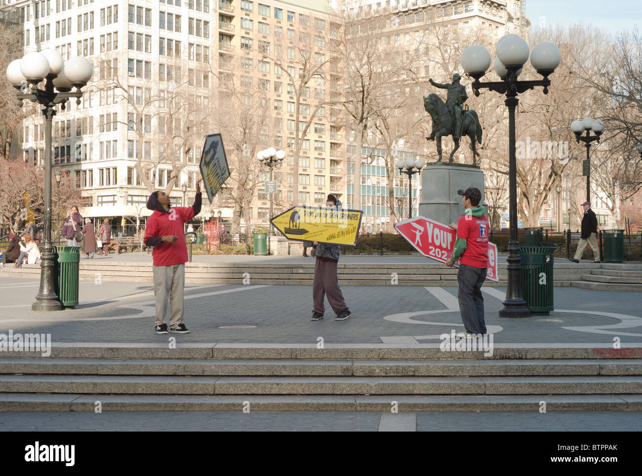 Sign spinners spin their advertising signs in Union Square Park Stock Photo  - Alamy, image size:1300x964