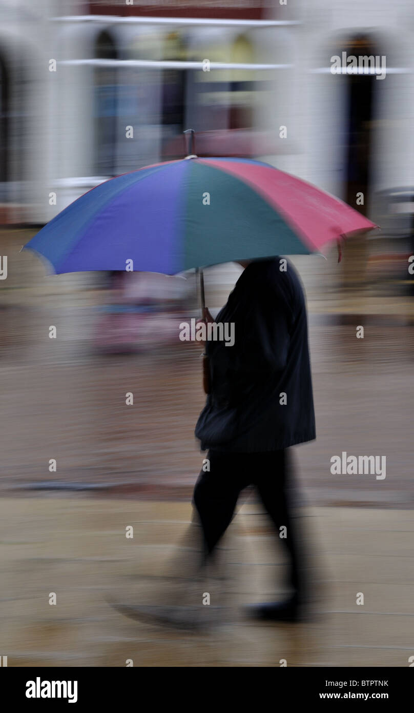 Man walking with umbrella Stock Photo - Alamy