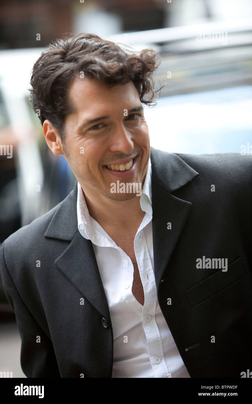 Young man looking at camera smiling , portrait of a man Stock Photo - Alamy