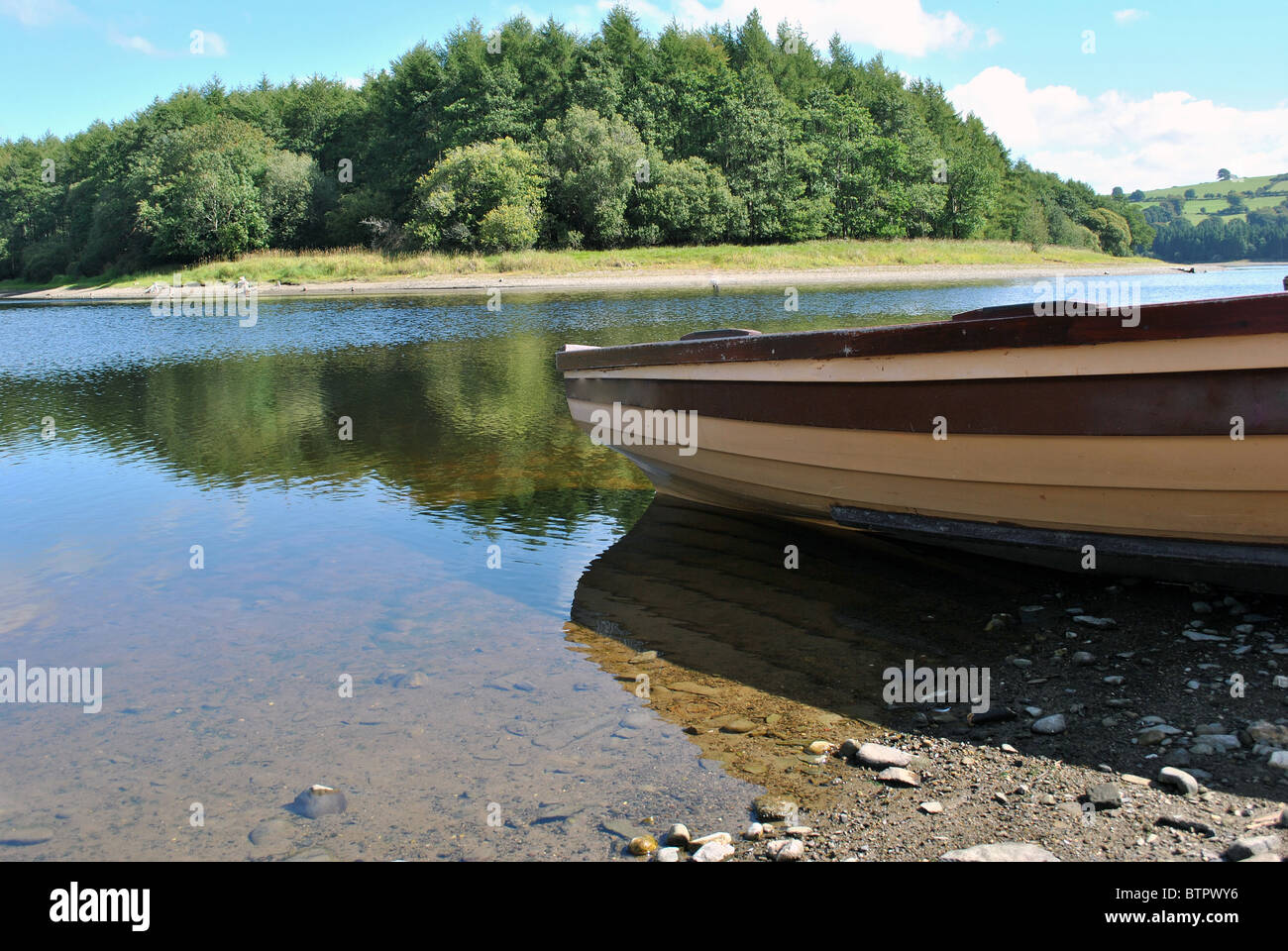 small boat on a lake shore Stock Photo