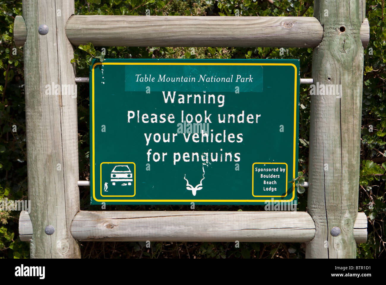 Warning notice 'please look under your vehicles for penguins' Stock Photo