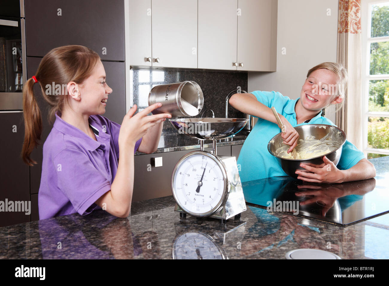 Girls cooking in the kitchen Stock Photo