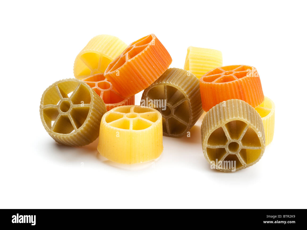 heap of ruote tricolori pasta wheels on white background Stock Photo