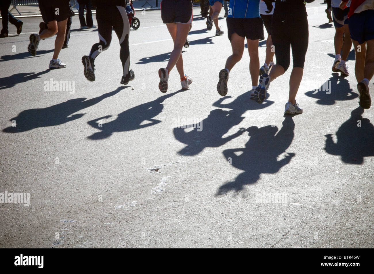 Runners pass through Harlem in the ING New York City Marathon on Sunday, November 7, 2010 Stock Photo