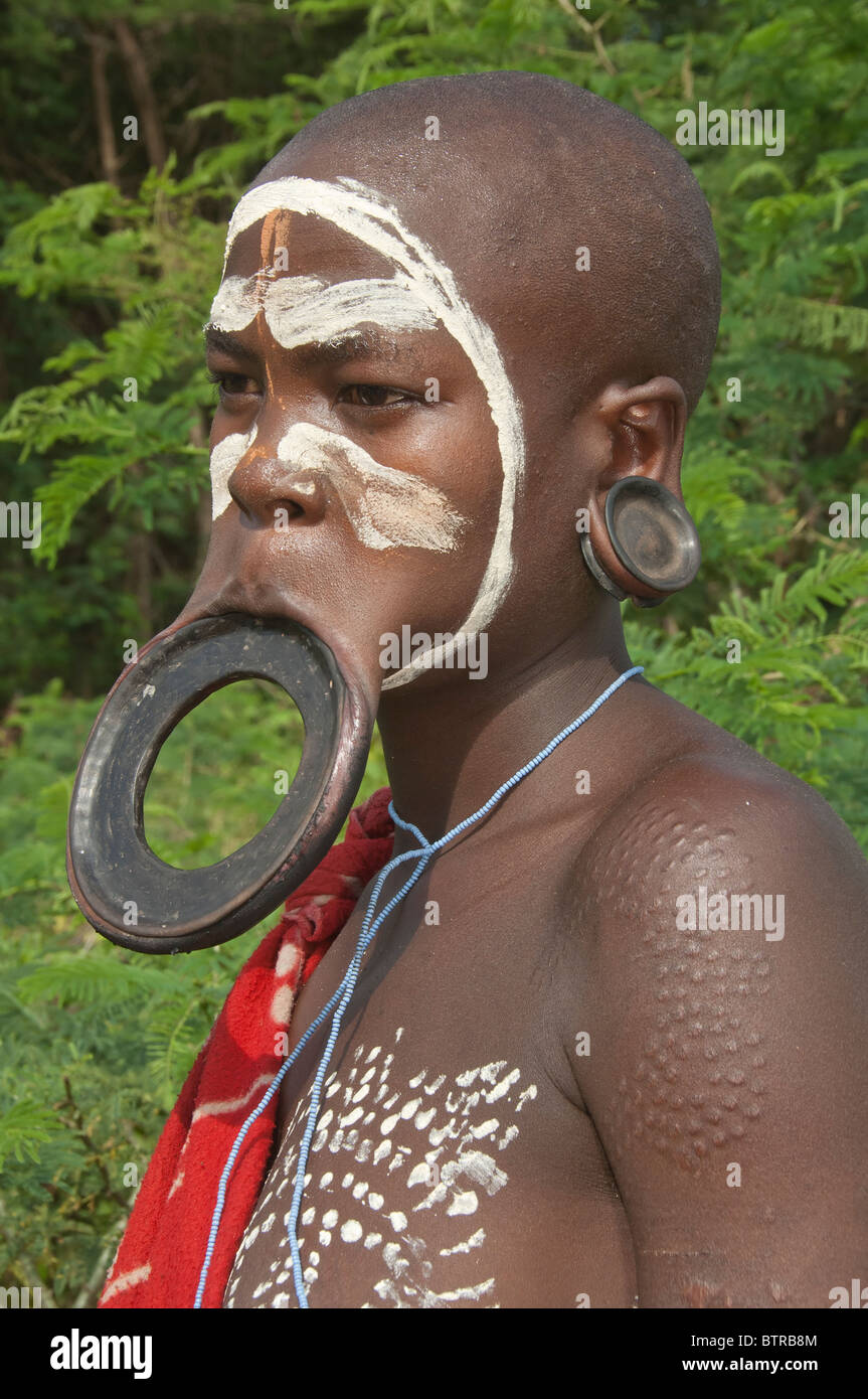 Surma woman with lip and ear plate, Kibish, Omo River Valley, Ethiopia Stock Photo