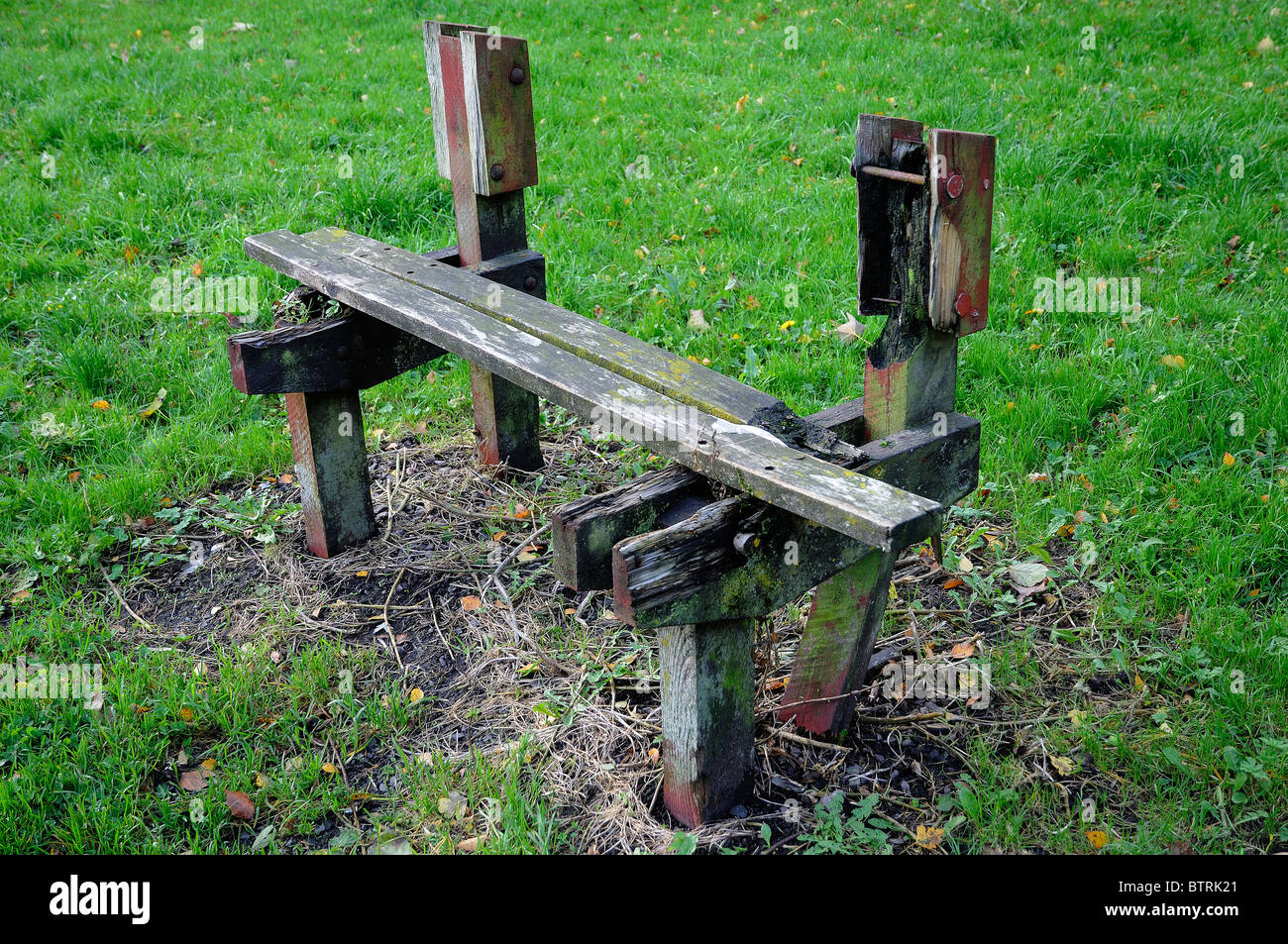 delapidated damaged park bench Stock Photo