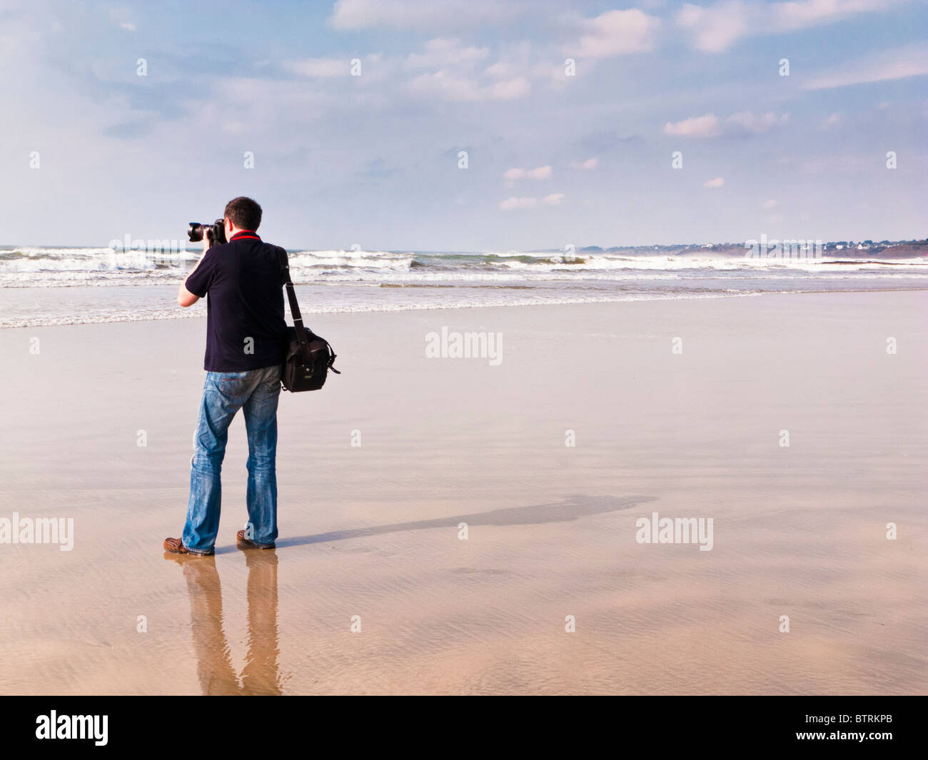 Photographer on a deserted beach shooting the ocean France Europe Stock Photo
