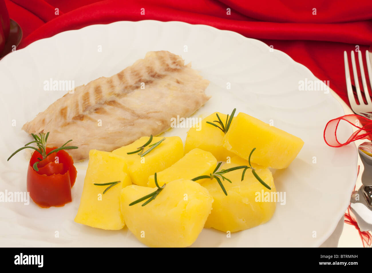 Plate of fish on Christmas dinner table. Stock Photo