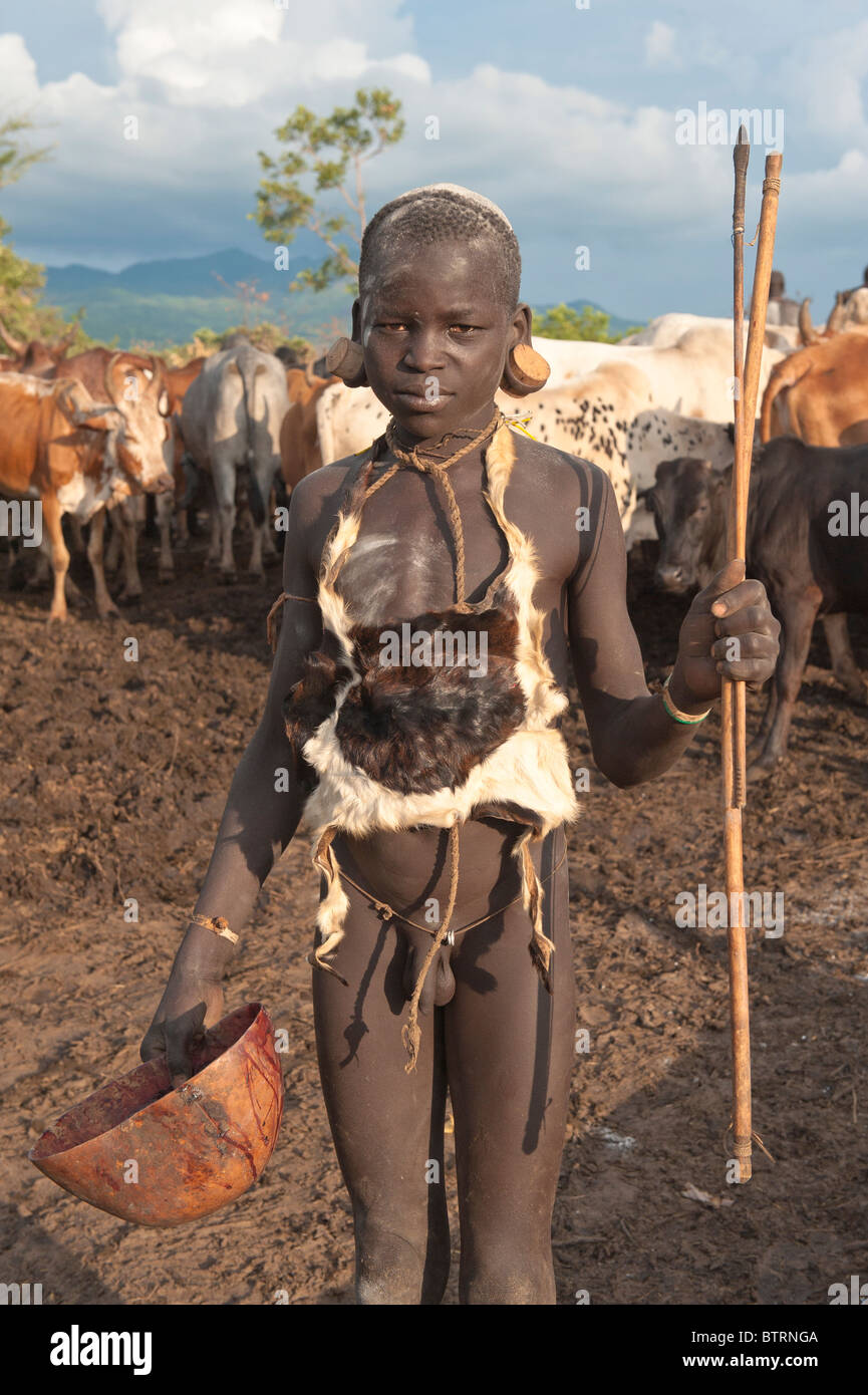 Surma boy in a cattle camp near Tulgit, Omo River Valley, Ethiopia Stock Photo