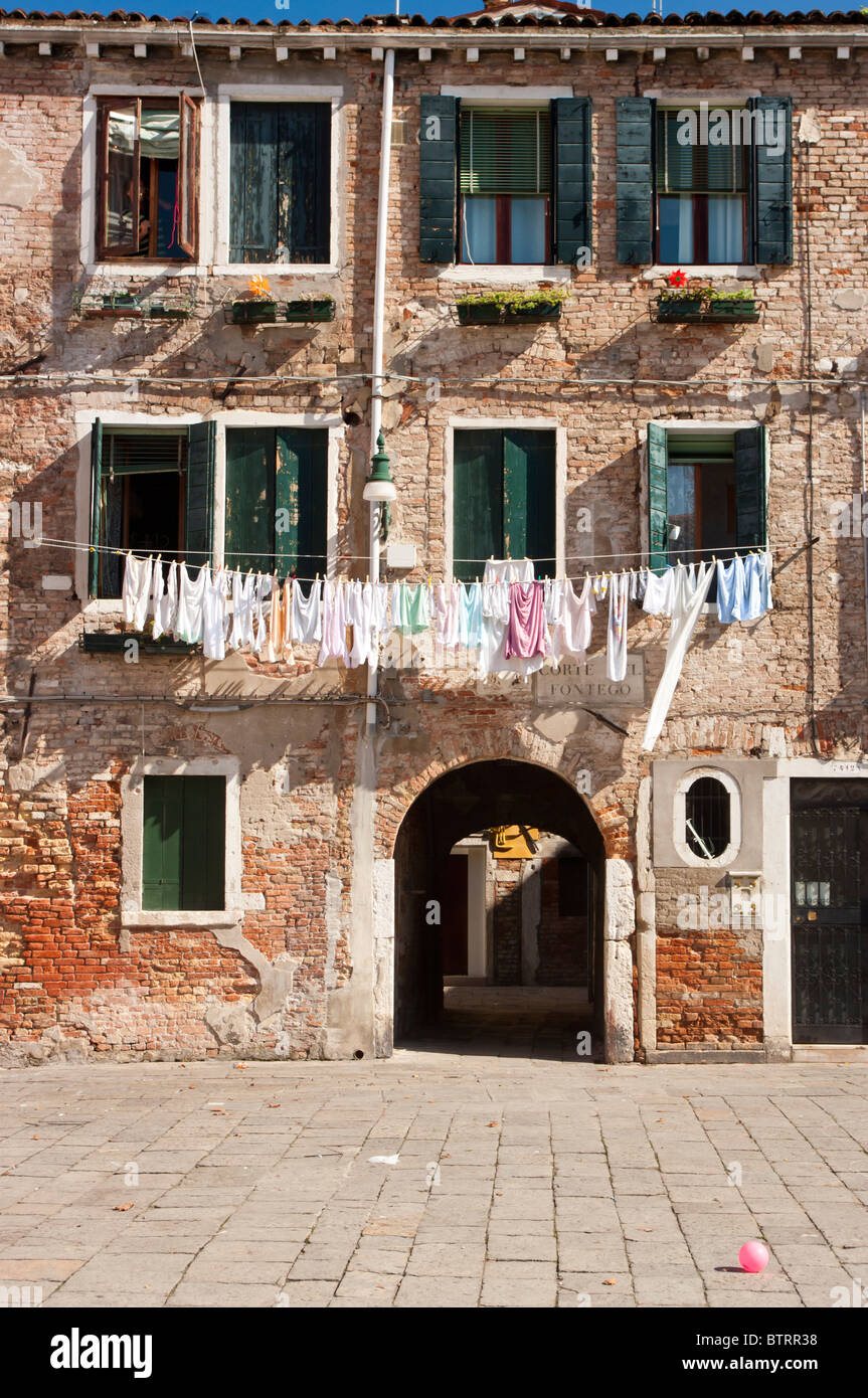 Venetian old bricks building with washing on washing line,Venice,Italy Stock Photo