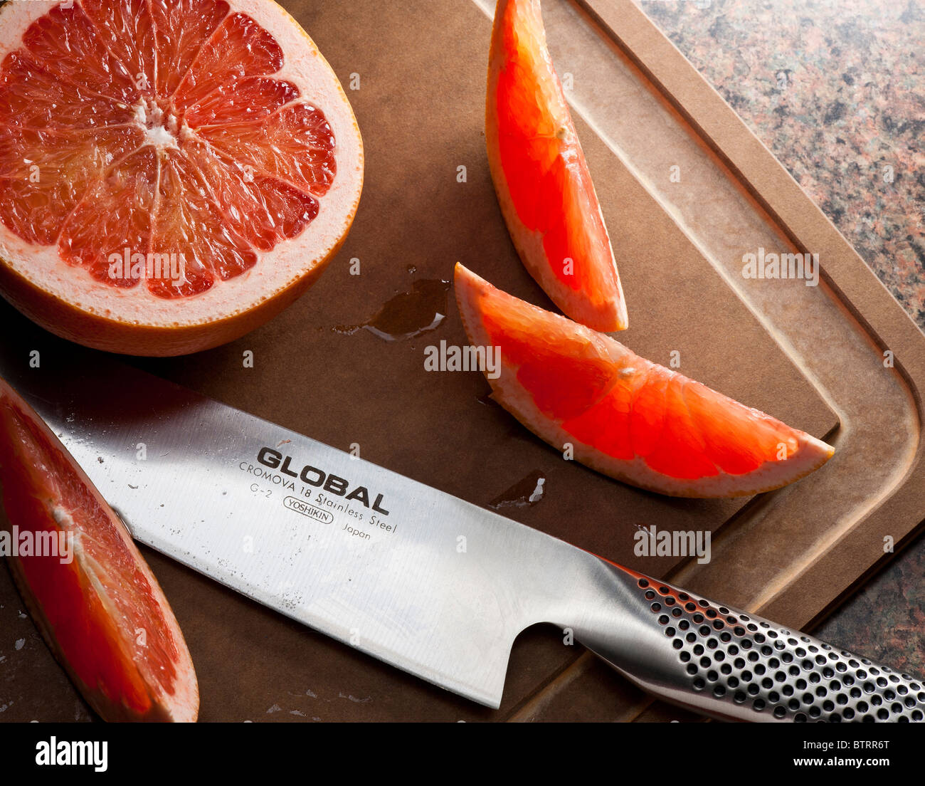 SLICED GRAPEFRUIT AND KNIFE Stock Photo Alamy