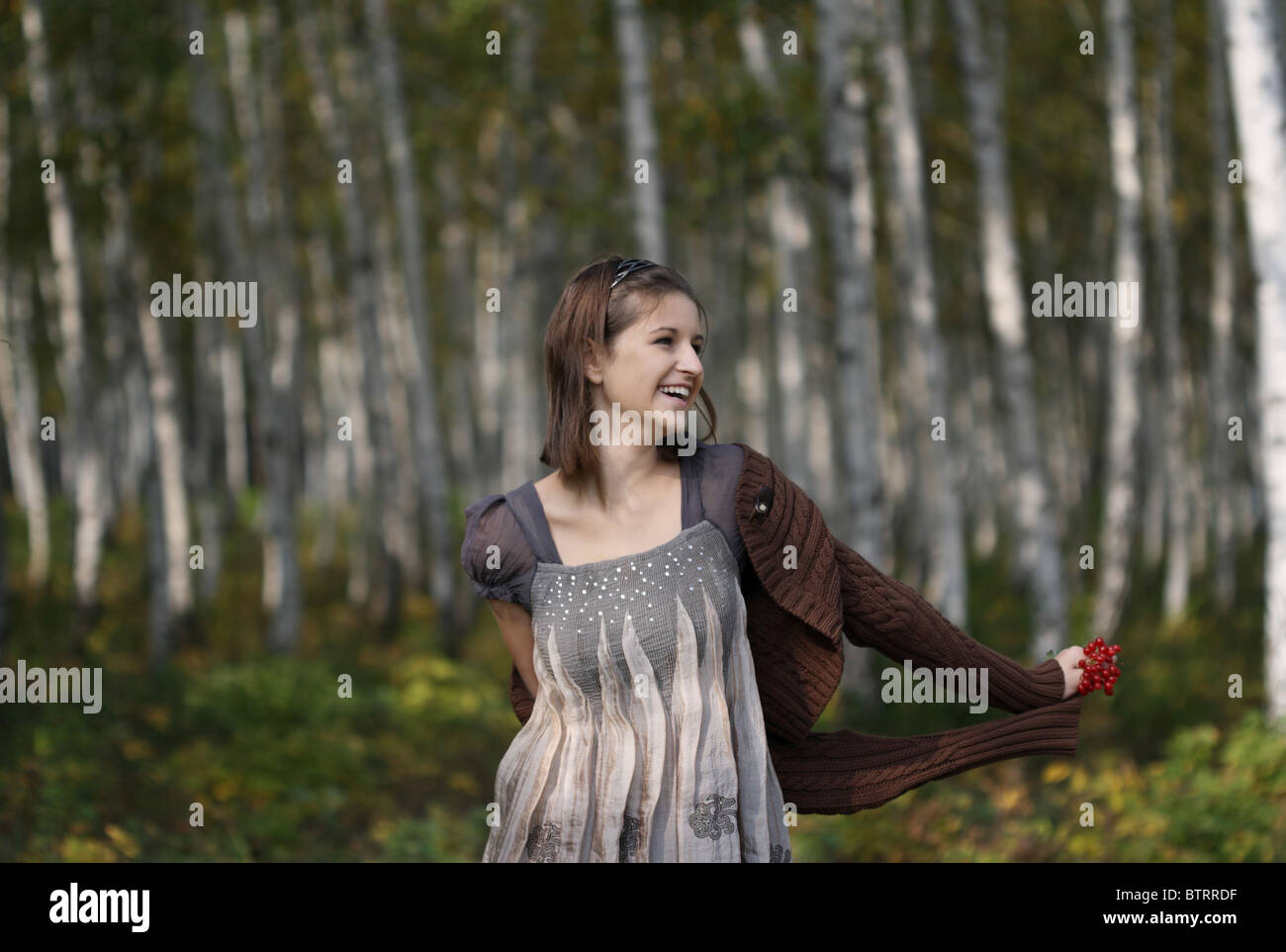 Portrait of pretty young girl in autumn forest Stock Photo - Alamy