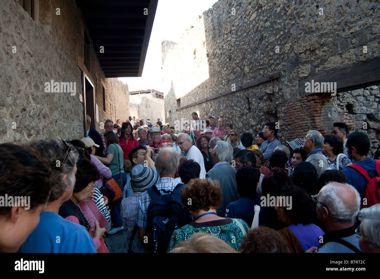 Crowd of visitors at the Lupanar of Pompeii, the most famous brothel in the ruined Roman city of Pompeii. Stock Photo