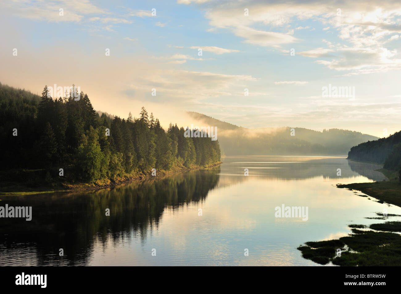 Golden sunbeam shine through the Sösestausee in Harz,Germany. Stock Photo