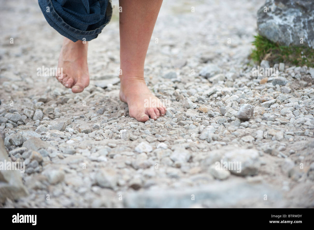 A barefoot pilgrim climbing Croagh Patrick, Co. Mayo, Ireland Stock