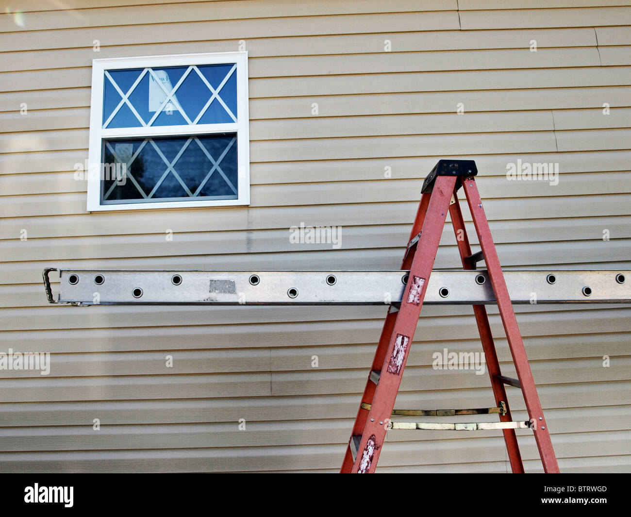 ladder scaffold vinyl siding house construction stepladder Stock Photo