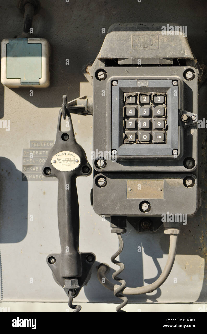 Old, weathered industry telephone with push dialing from