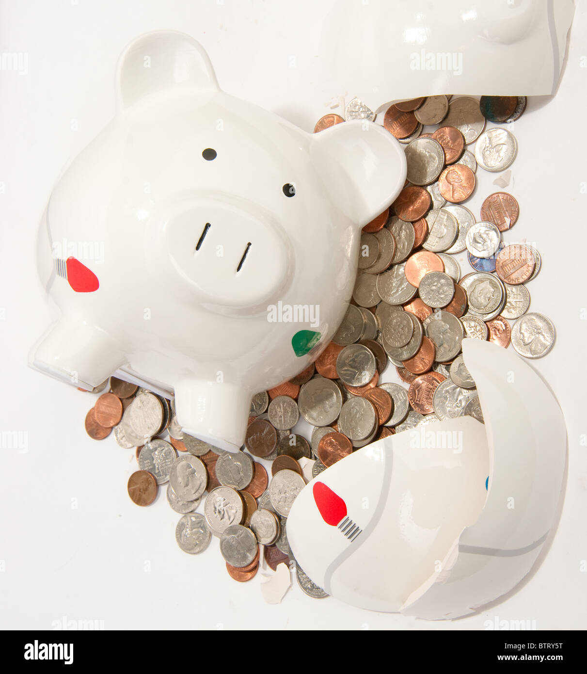 Broken Piggy Bank with coins flowing out Stock Photo - Alamy