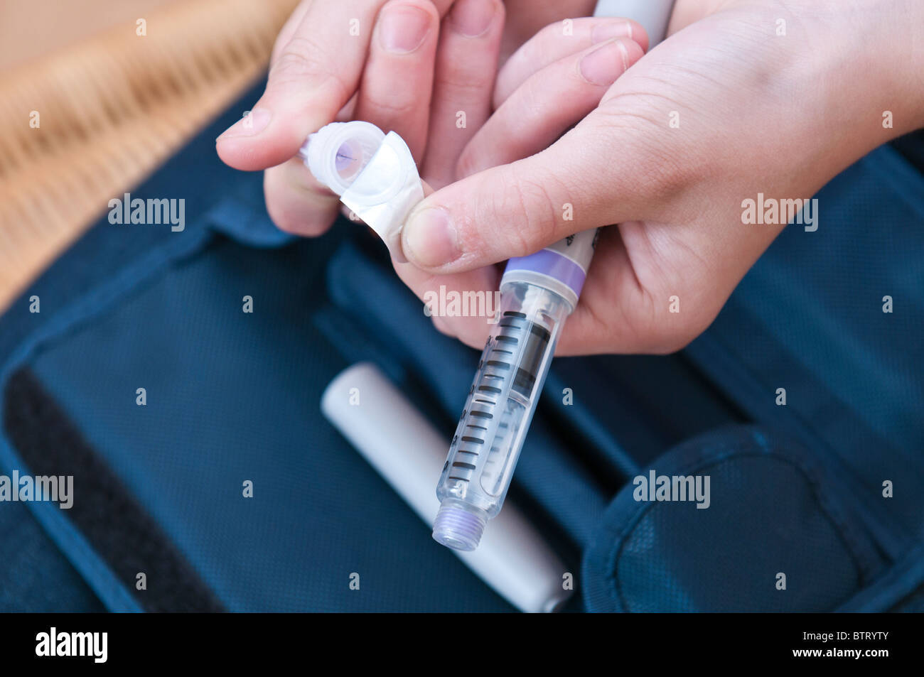 Young diabetic girl prepares an injection of insulin to treat diabetes