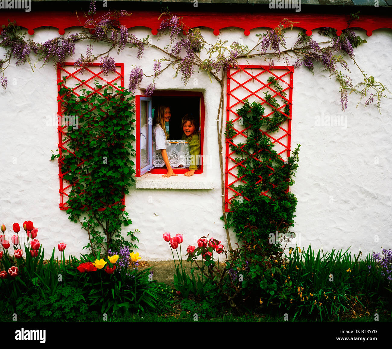 Kenmare, Ring Of Kerry, Co Kerry, Ireland; Children Looking Out Of A Cottage  Window Stock Photo - Alamy