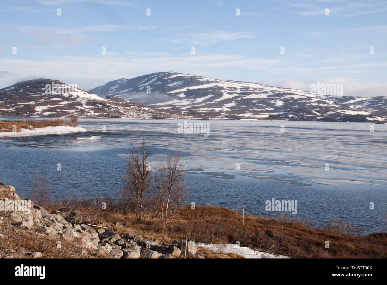 Melting ice on mountain lake Riksgransen   Lappland Sweden Stock Photo