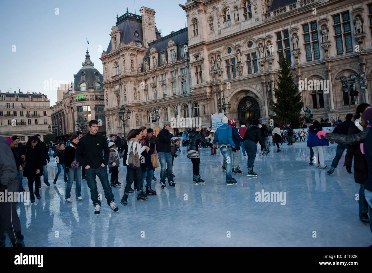 Teenagers Ice Skaters on Ice Skating Rink at Paris City Hall Building