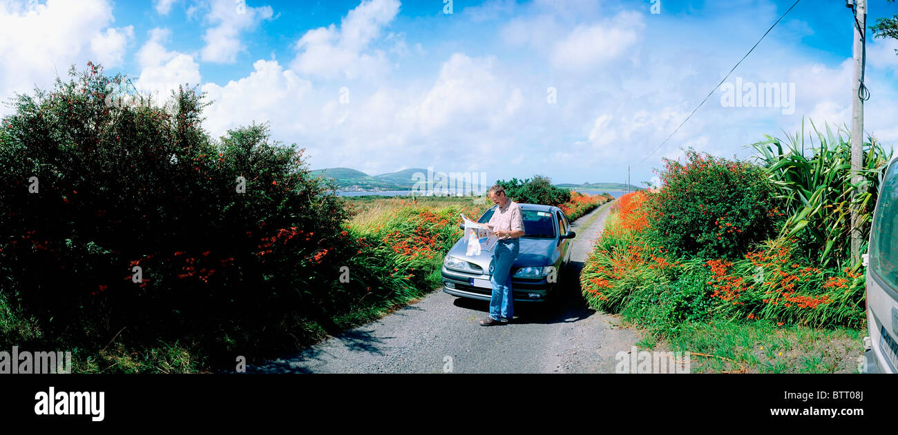 Cahirciveen, Co Kerry, Ireland, Man Standing By His Car On A Country Road Stock Photo