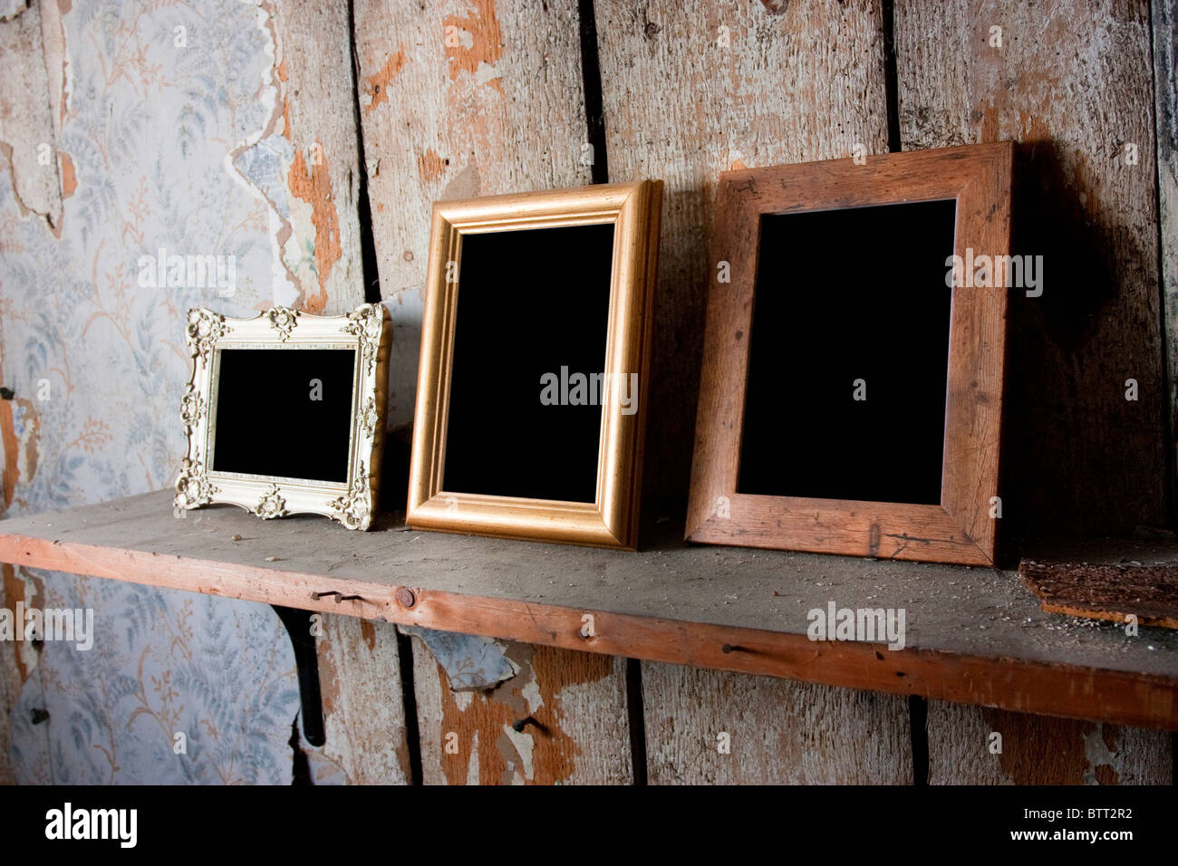 selection of empty blank picture frames in an old attic room Stock Photo