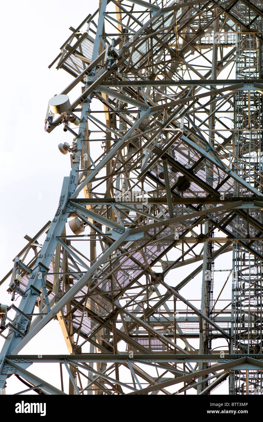 Detail of a complex communication tower with steel struts and microwave dishes. Stock Photo