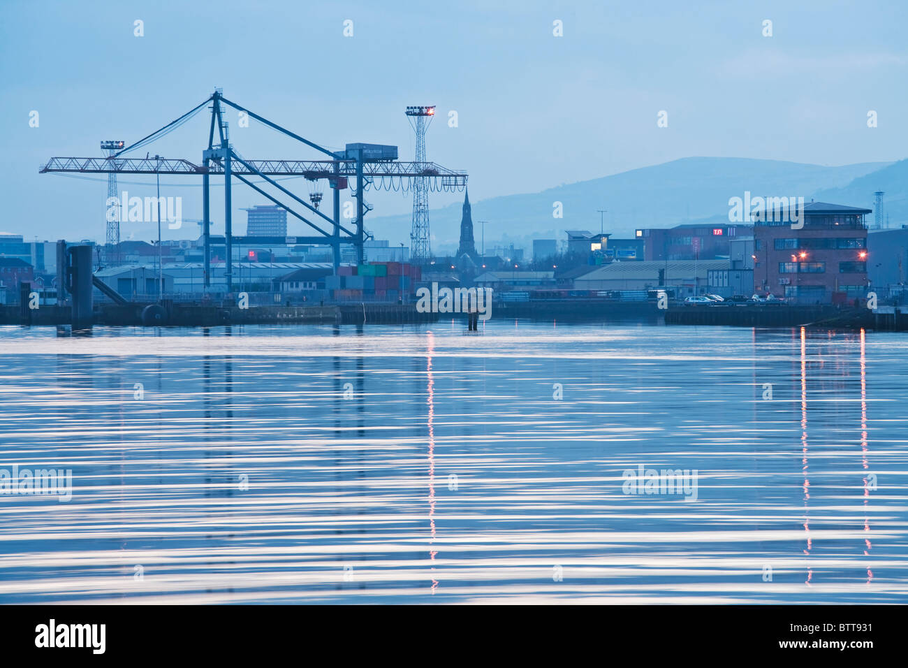 The cranes of Belfast dock reflected in the River Lagan at dusk, Northern Ireland Stock Photo