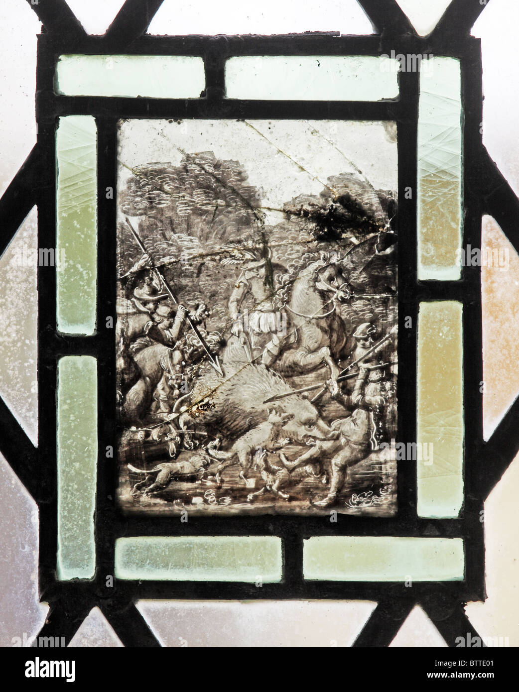 A stained glass window depicting a wild boar hunt, Flemish School, circa 17th century, Teffont Evias Church, Wiltshire, England Stock Photo